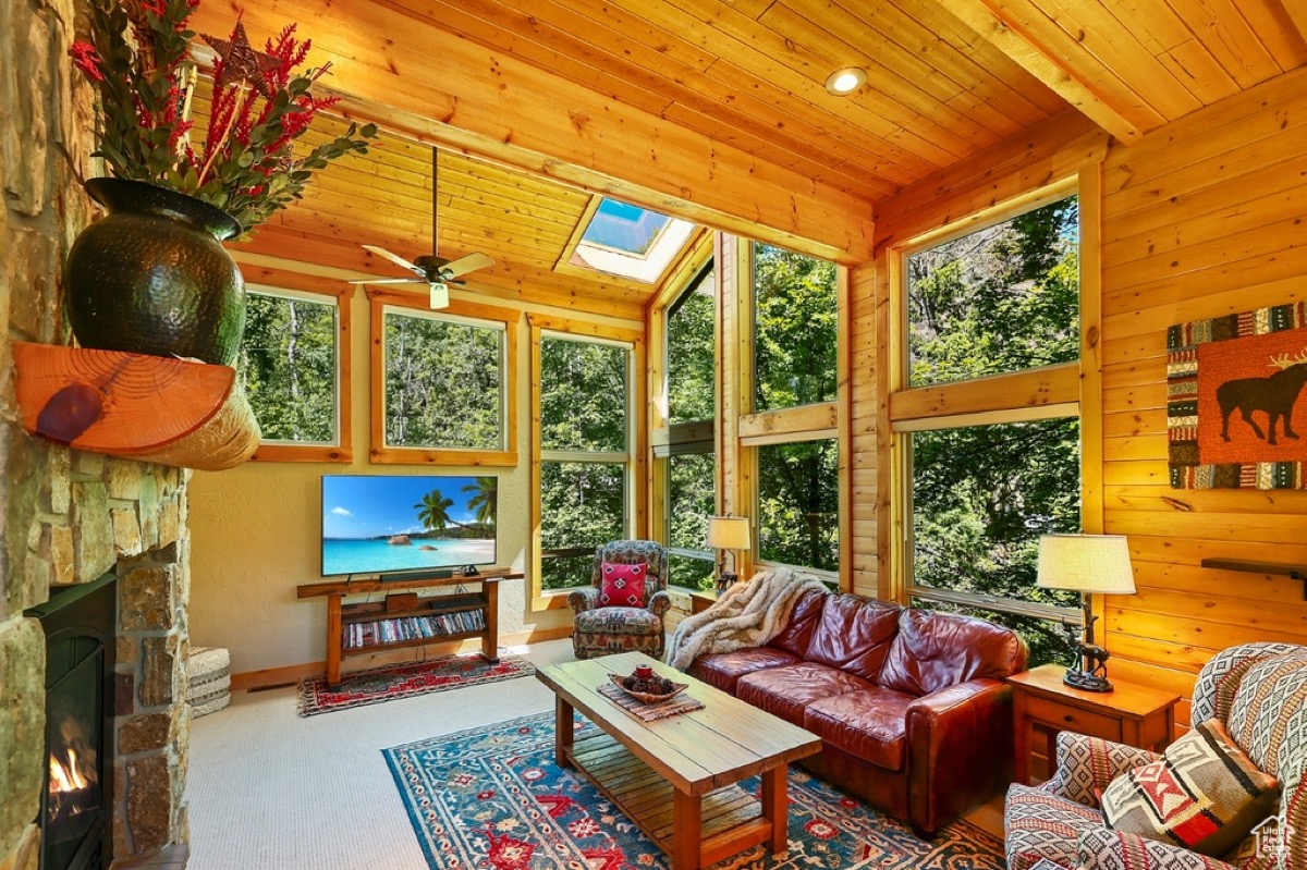Interior living area with stone fireplace and vaulted ceiling at Timp Haus