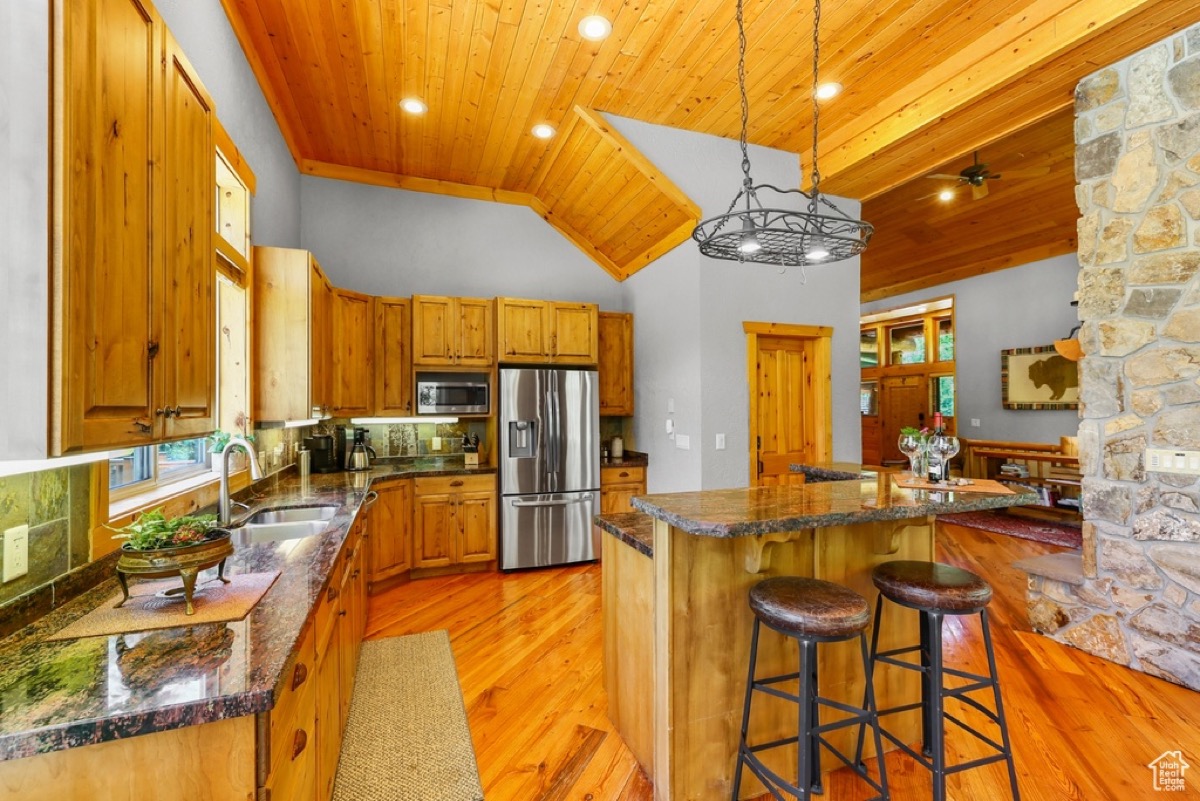 Island kitchen with stainless appliances and barstools at Timp Haus